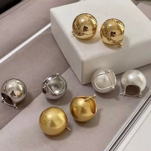Chic vintage style spherical metal earrings set in polished gold and silver finishes