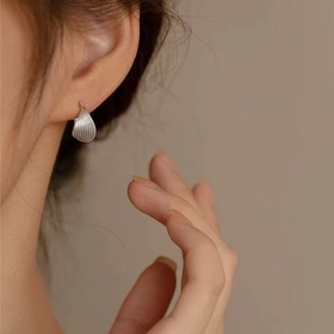 Elegant silver waterdrop earrings with vertical textured finish for a minimalist chic look