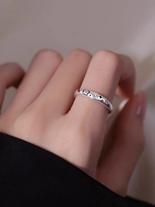 Detailed macro view of S925 silver flower ring with pink zircons and black enamel