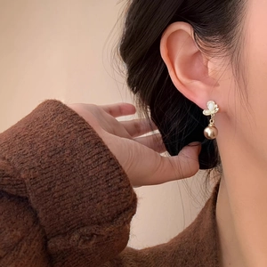 Elegant champagne butterfly drop earrings with shimmering crystals and a warm pearl bead