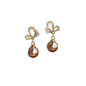Elegant champagne pearl earrings with gold butterfly pendant and shimmering crystals