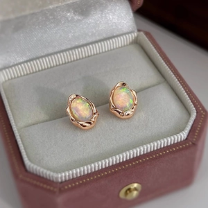 Detail of vintage French earrings with oval opals set in rose gold organic mounts