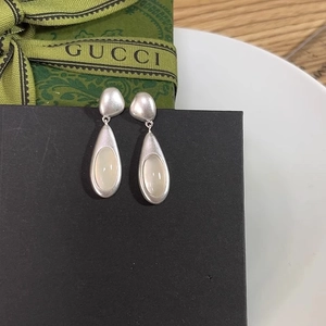 Minimalist matte silver water drop earrings with milky white oval stone in a retro design