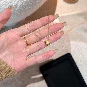 Elegant gold barrel necklace and matching ring set with frosted texture on delicate chain