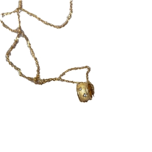 Elegant gold cylinder pendant necklace with brushed finish and sparkling star-set stones