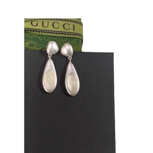 Minimalist silver teardrop earrings with oval opal stone on black display card