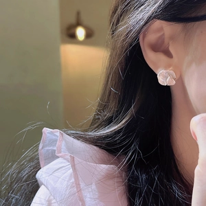 French vintage camellia stud earrings with pearl luster on a model for an elegant look