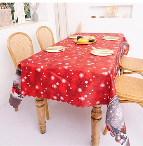 Close-up of festive red polka dot tablecloth with winter landscape print and wavy edges