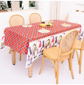 Detail of Christmas tablecloth with red plaid gnomes and scalloped wavy edges