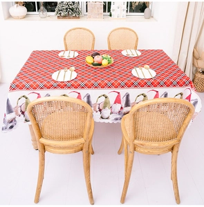 Close-up of wavy edges on a red plaid Christmas gnome tablecloth for holiday parties