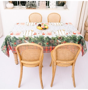 Detail of Christmas tablecloth with pine needles, cones, berries and Merry Christmas print
