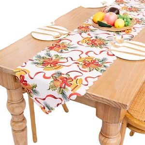 Christmas table runner with festive bells and pine print on white fabric for holiday decor