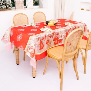 Festive red Christmas tablecloth with snowflake prints and decorative scalloped edges