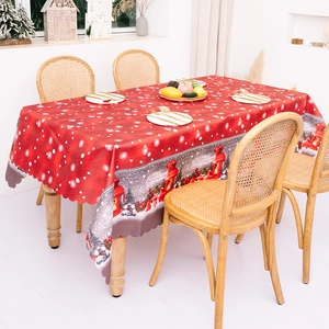 Red Christmas gnome tablecloth with white dots and wavy edges for holiday dining table decor