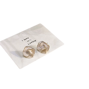 French vintage camellia stud earrings in cream white with gold edges on a display card