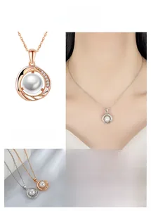 Detail of spiral pearl necklace with sparkling pavé stones and fine link chain