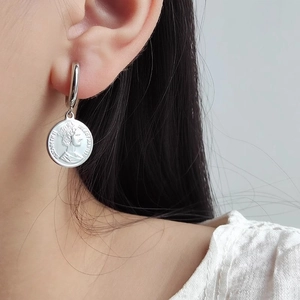 Silver vintage coin drop earrings featuring Elizabeth II portrait on a light background