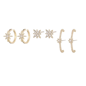 Detail view of gold star and moon earring set with cubic zirconia stones and dangles