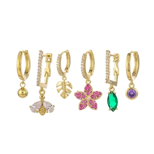 Detail view of 6-piece gold earring set featuring bee, leaf and colorful crystal charms