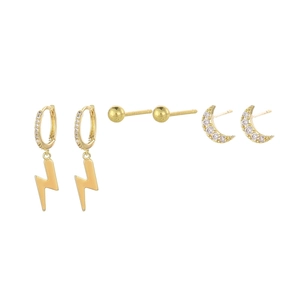 Detailed view of three-piece gold earring set featuring moon, lightning, and ball studs