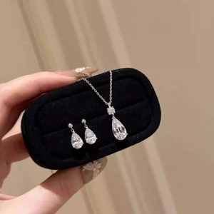 Elegant teardrop necklace and earring set in a velvet jewelry box with silver finish