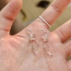French style silver ribbon bow earrings with spiral tassels and a matching thin ring