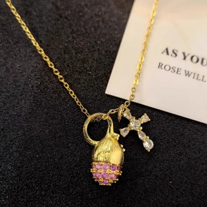 Gold necklace featuring pink zircon pinecone and sparkling cross pendant for women