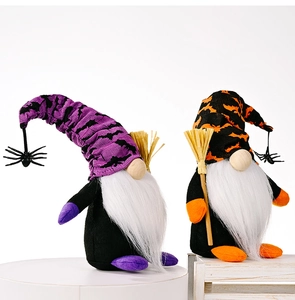 Close-up of Halloween spider and broom gnome dolls with velvet hats and plush beards