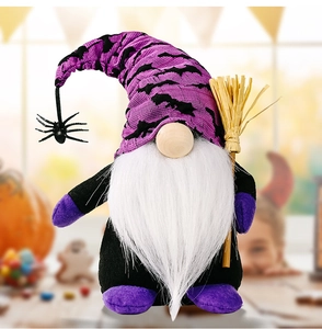 Close-up of Halloween gnome plush toy with bat pattern hat and small straw broom accessory