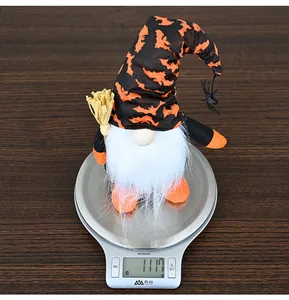 Macro shot of a 111.7g Halloween gnome plush with a bat-patterned hat and straw broom