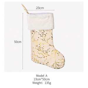 Detailed view of cream Christmas stocking with gold branch patterns and faux fur trim