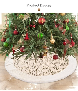 Detail of plush Christmas tree skirt featuring elegant gold branch patterns and white fur trim