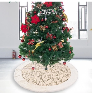 Detail of beige Christmas tree skirt with gold branch pattern and white faux fur edge