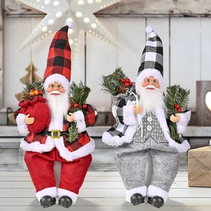 Close-up of sitting Santa resin dolls with plaid fabric outfits and holiday details