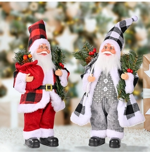 Detailansicht von zwei Weihnachtsmannfiguren mit Karomantel und Kiefernzweigen zur Deko
