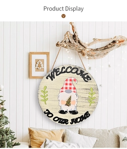 Detail of wooden welcome sign featuring a festive gnome and Christmas tree illustration