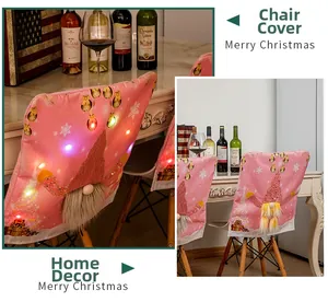 Pink Christmas gnome chair cover with colorful LED lights for festive dining room decor