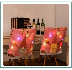 Detail of pink Christmas gnome chair covers with glowing LED lights and red sequin hats