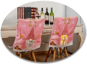 Close-up of pink Christmas chair covers with gnome design and sequin embroidery details