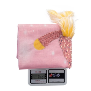 Pink Christmas chair cover detail showing fine fabric texture and 148g weight on scale