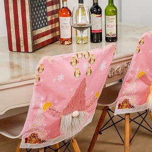 Pink Christmas chair cover with light-up Rudolph gnome and festive snowflake patterns
