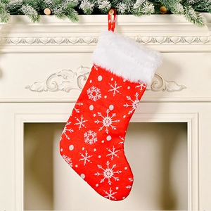 Red Christmas stocking with snowflake embroidery hanging on a festive mantel