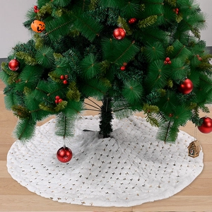 Detail of white plush Christmas tree skirt with festive gold sequin star embroidery