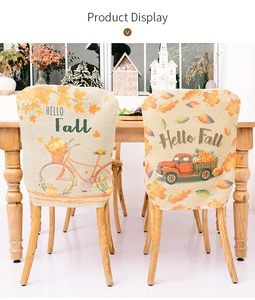 Detail of harvest-themed chair covers with pumpkins, fall leaves and Hello Fall text