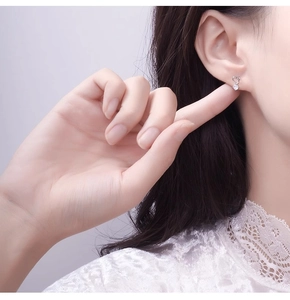 Gros plan sur la boucle d'oreille cœur minimaliste avec zircon sur le mannequin