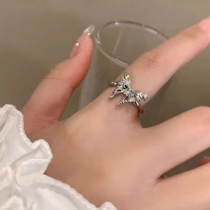 Irregular silver butterfly open ring with crystal stones on female hand with lace cuff