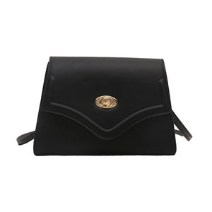 Minimalist black leather crossbody bag with V-shaped flap and gold oval twist lock closure