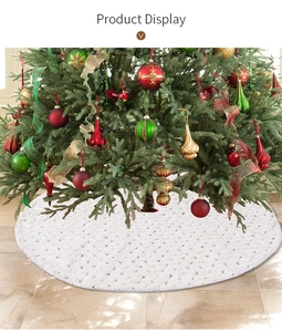 Detail of white quilted Christmas tree skirt featuring shiny silver sequin star patterns