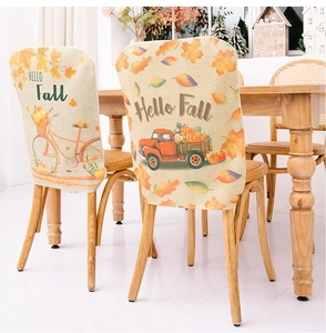 Detail of harvest harvest chair covers with pumpkin truck and maple leaf print