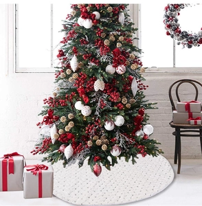 Detail of white round Christmas tree skirt with silver sequins and quilted texture
